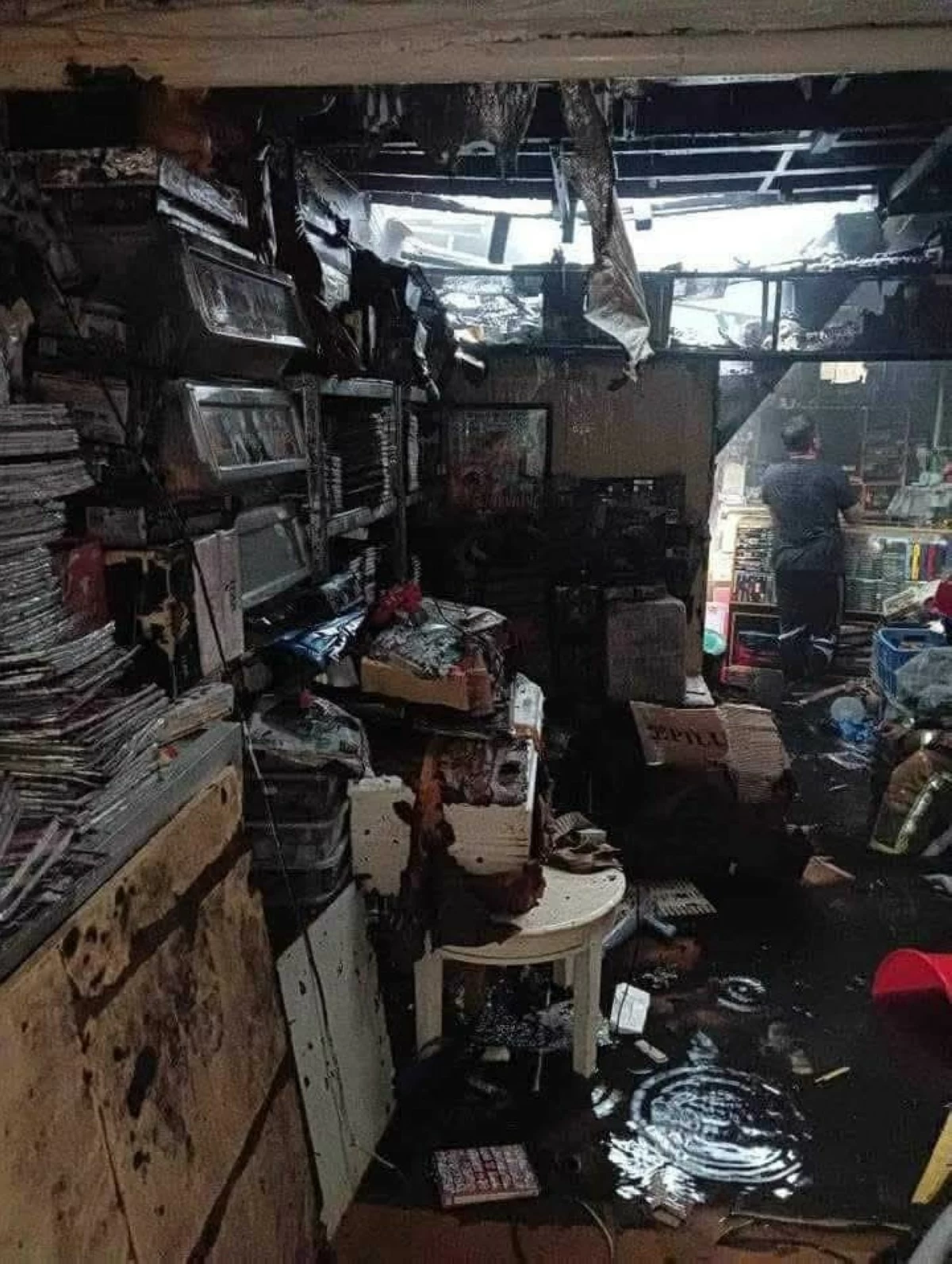 Erwin Esteban (right) ponders his fate and that of his business (Retrogamerph Store) after a May 10, 2024 fire destroyed nearly everything he owned.
