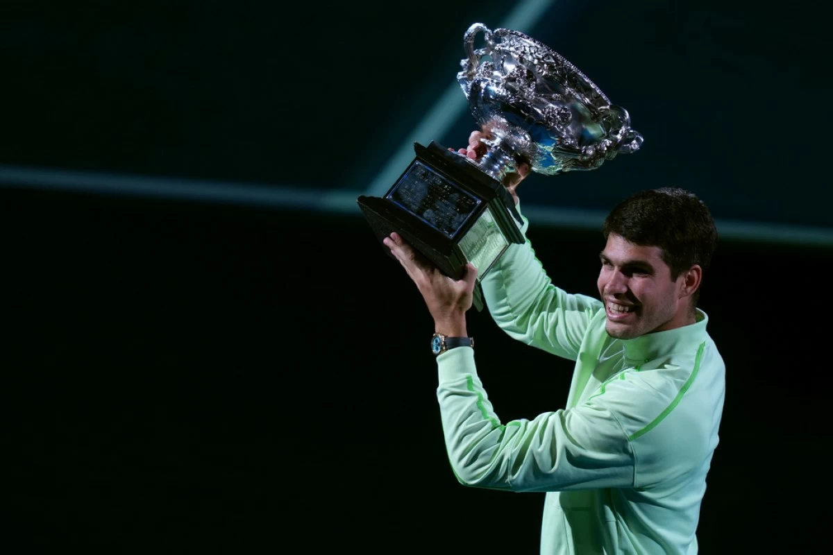 Carlos Alcaraz of Spain holds the Norman Brookes Challenge Cup after defeating Novak Djokovic of Serbia in the men's singles final at the Australian Open tennis championship in Melbourne, Australia, Sunday, Feb. 1, 2026. (AP Photo/Asanka Brendon Ratnayake)