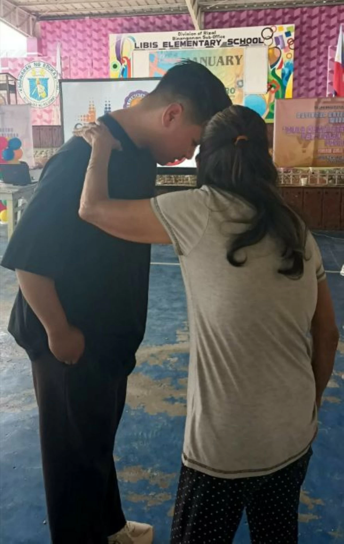 Gelo Pajarillo listens to a beneficiary of the medical mission and outreach program (photo courtesy of the program organizers)
