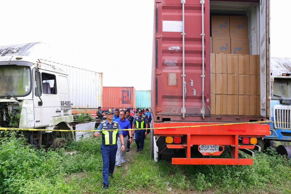 Police Lt. Gen. Jose Melencio Nartatez Jr., acting Philippine National Police (PNP) chief, leads an inspection of allegedly smuggled cigarettes discovered during an anti-carnapping operation in Batangas City on Dec. 31, 2025. The seized products have an estimated value of P1.1 billion, according to authorities. (Photo: PNP)