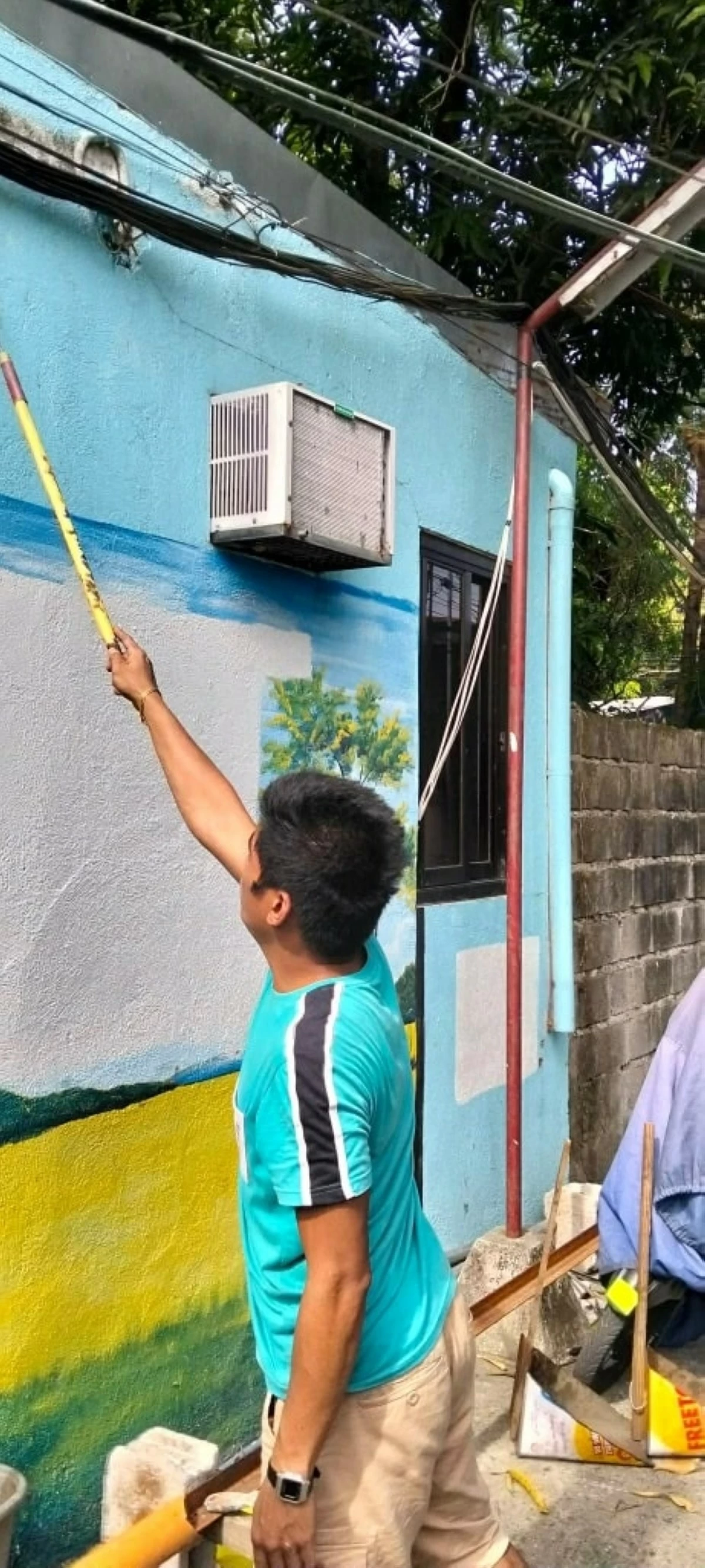 Personnel repaint a wall that previously bore the names of barangay officials in Imus City (Photo from the City Government of Imus’ Facebook page/MANILA BULLETIN)