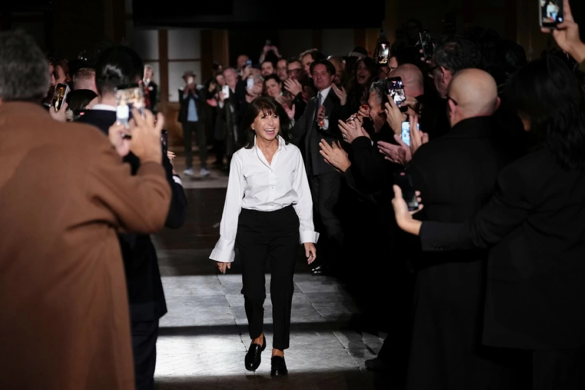 Designer Veronique Nichanian accepts applause after the Hermes Fall/Winter 2026-2027 Men's collection presented in Paris, Saturday, Jan. 24, 2026. (AP Photo/Aurelien Morissard)