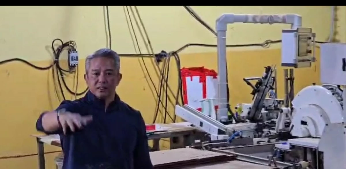 DILG Secretary Jonvic Remulla inspects the machines being used in the manufacture of cigarettes following a raid on an illegal factory in Pampanga that can produce P140 million worth of cigarettes a day. 
