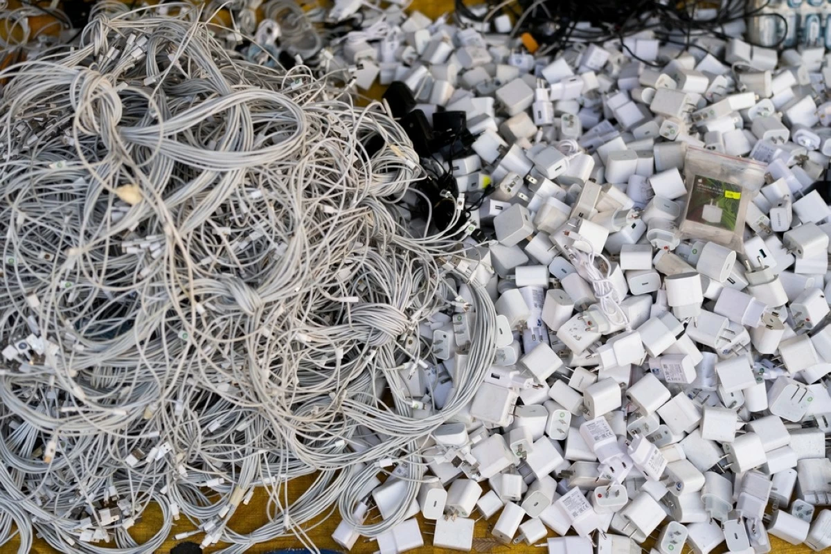 FILE -Used charging cables and power adapters are piled up at a shop in Nhat Tao market, the largest informal recycling market in Ho Chi Minh City, Vietnam, Jan. 28, 2024. (AP Photo/Jae C. Hong, File)