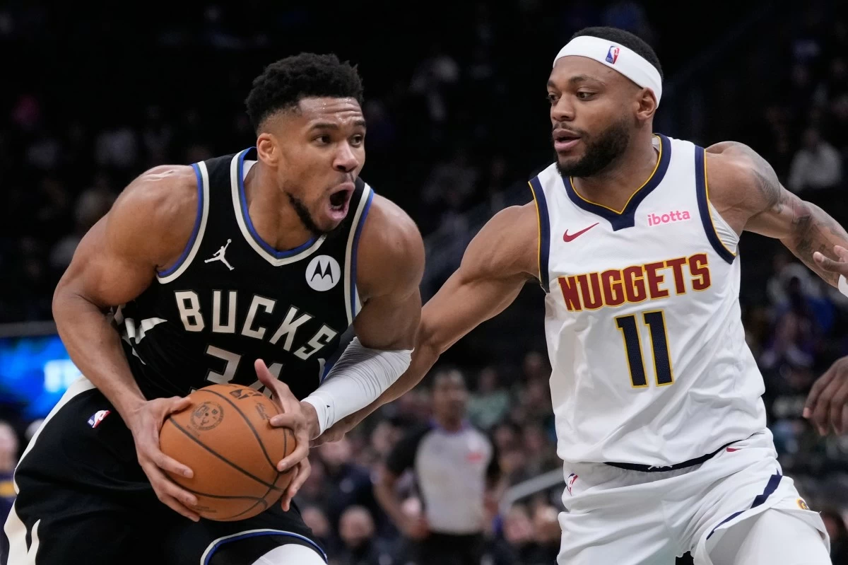 Milwaukee Bucks' Giannis Antetokounmpo tries to drive past Denver Nuggets' Bruce Brown during the second half of an NBA basketball game Friday, Jan. 23, 2026, in Milwaukee. (AP Photo/Morry Gash)