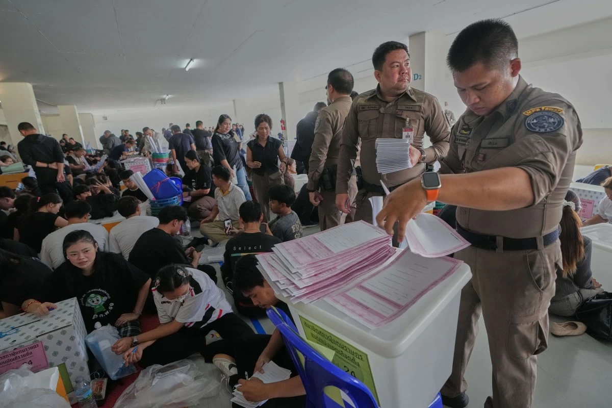 Police officers and Volunteers check ballots for Sunday's general election in Bangkok, Thailand, Saturday, Feb. 7, 2026. (AP Photo/Sakchai Lalit)