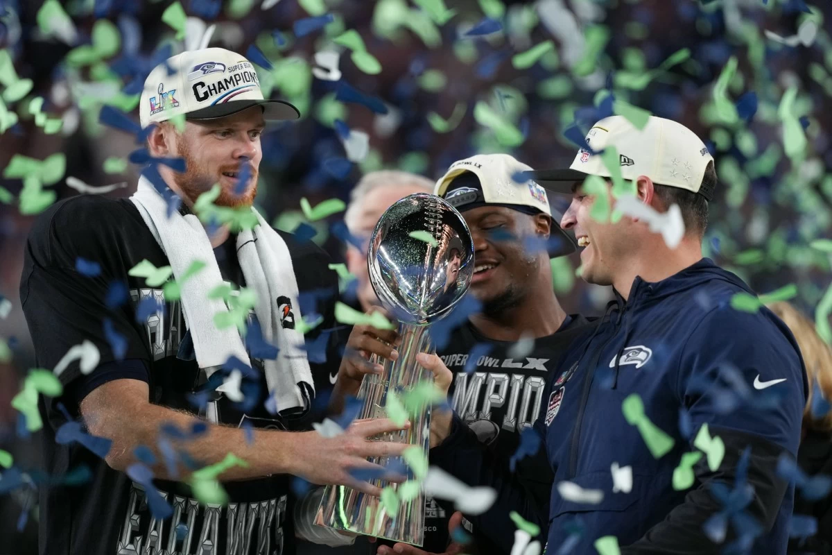 Seattle Seahawks head coach Mike MacDonald and quarterback Sam Darnold, left, hold the Lombardi Trophy after a win over the New England Patriots in the NFL Super Bowl 60 football game Sunday, Feb. 8, 2026, in Santa Clara, Calif. (AP Photo/Matt Slocum)