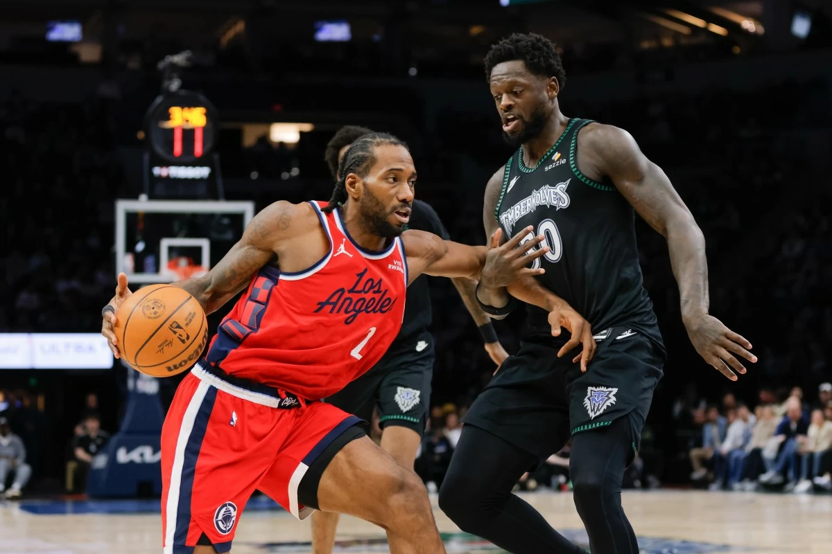 Los Angeles Clippers forward Kawhi Leonard, front left, dribbles while Minnesota Timberwolves forward Julius Randle (30) defends during the second half of an NBA basketball game, Sunday, Feb. 8, 2026, in Minneapolis. (AP Photo/Bailey Hillesheim)