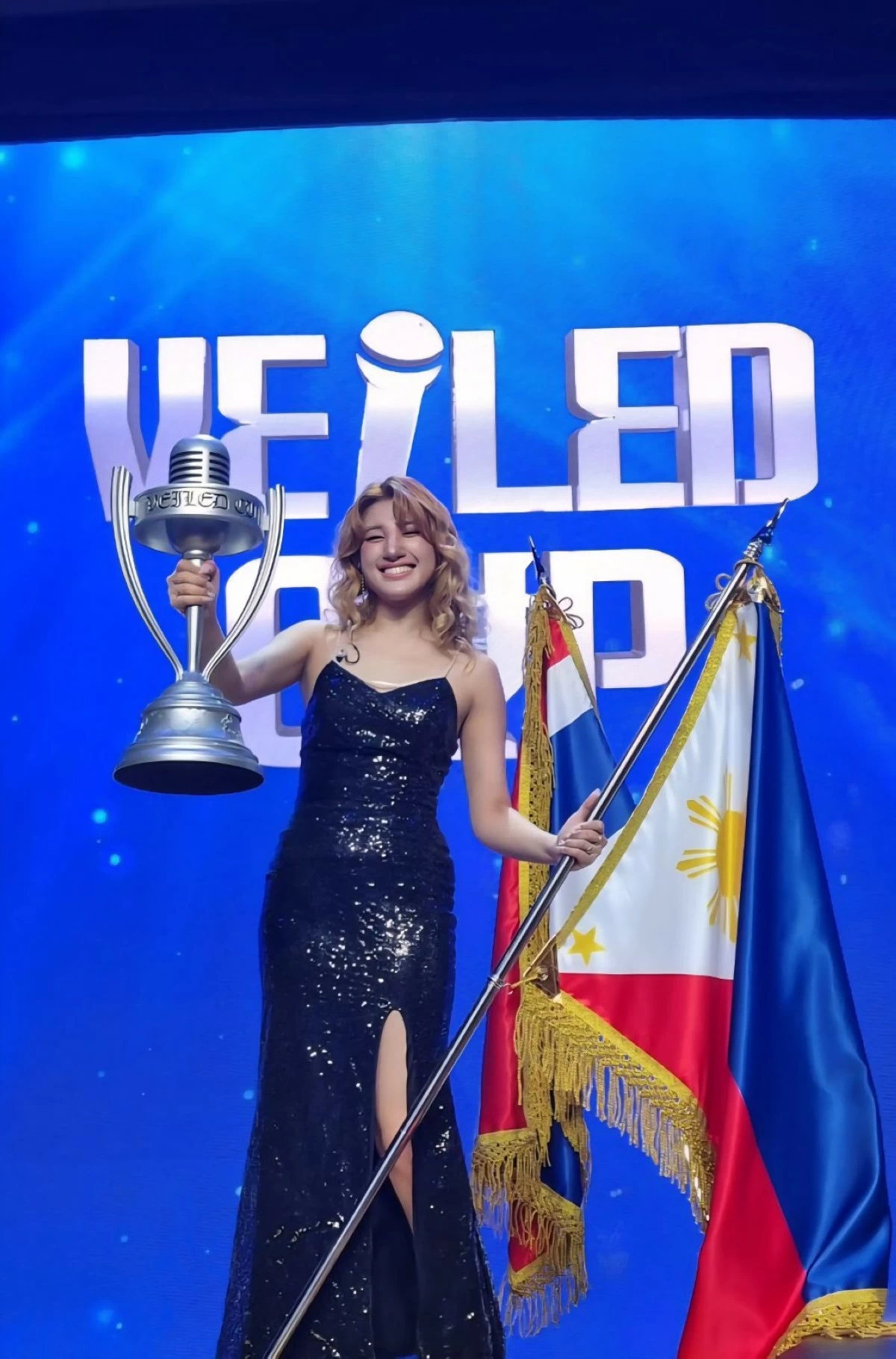 Arabelle Dela Cruz holds the trophy after she won at the Veiled Cup singing competition in Seoul, South Korea.