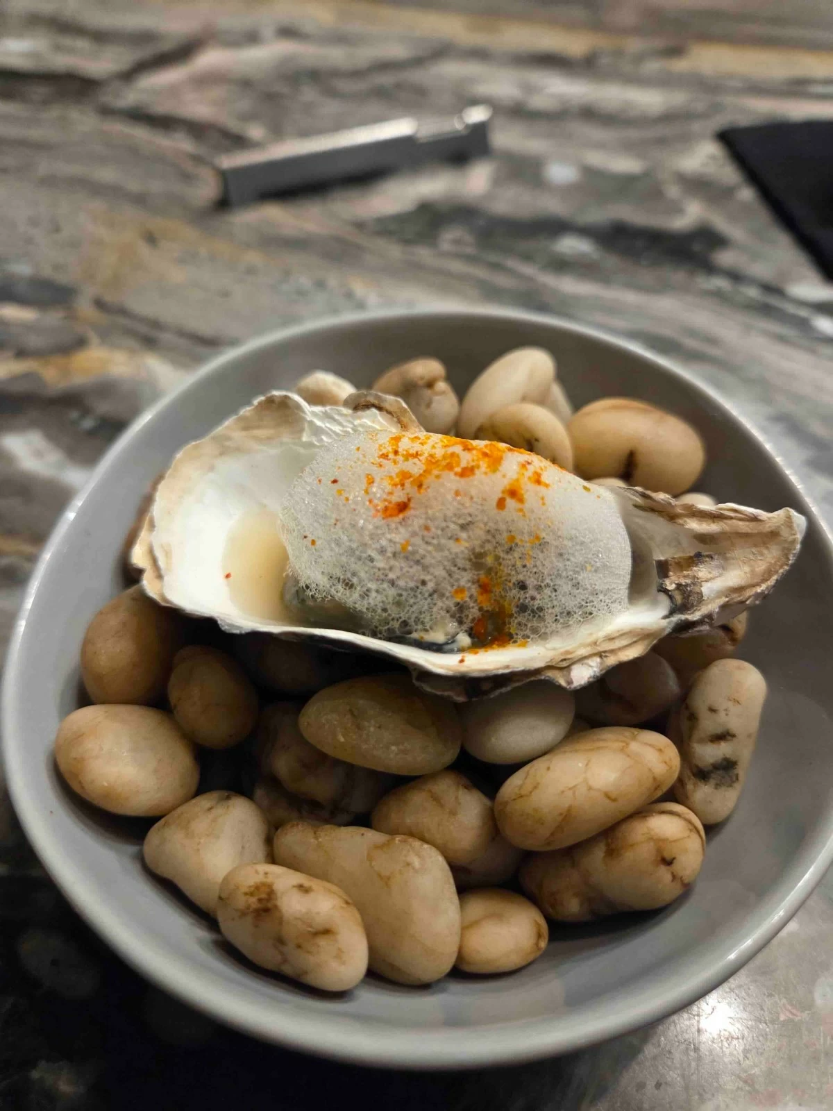 SOFT BRINE  Soft-poached Negros oyster served with oyster cream and sea foam.