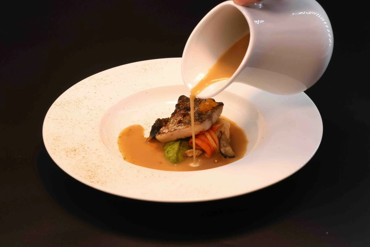 WHOLE FISH  Konbujime Asian bass prepared using the full fish, with fish milk, mustard aioli, vegetable noodles and fermented chili oil caviar.