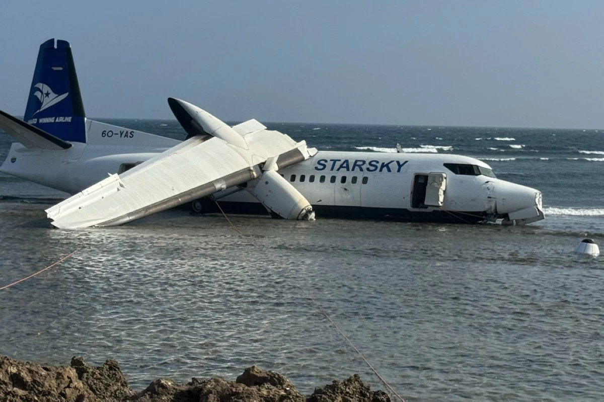 An aircraft carrying up to 50 people on the shoreline after veering off the runway during an emergency crash-landing at Somalia's main airport in Mogadishu, Somalia, Tuesday, Feb. 10, 2026. (AP Photo/Omar Faruk)