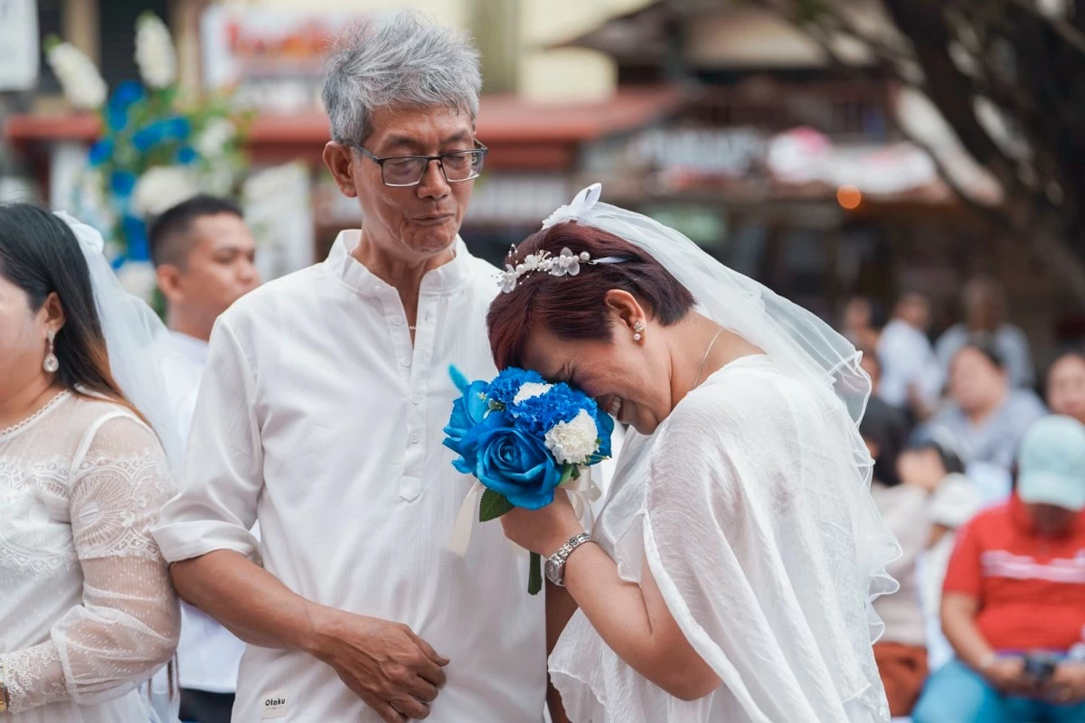 Marikina City Mayor Maan Teodoro solemnizes the marriage of 10 rider-couples in a mass wedding ceremony held at Kapitan Moy Plaza in Barangay Sta. Elena on February 12, 2026. (Photos from Marikina LGU)