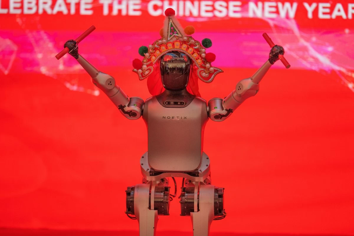 A humanoid robot wearing a traditional headdress is displayed during a media preview of a robotic temple fair ahead of Lunar New Year in Beijing, China, Friday, Feb. 13, 2026. (AP Photo/Vincent Thian)