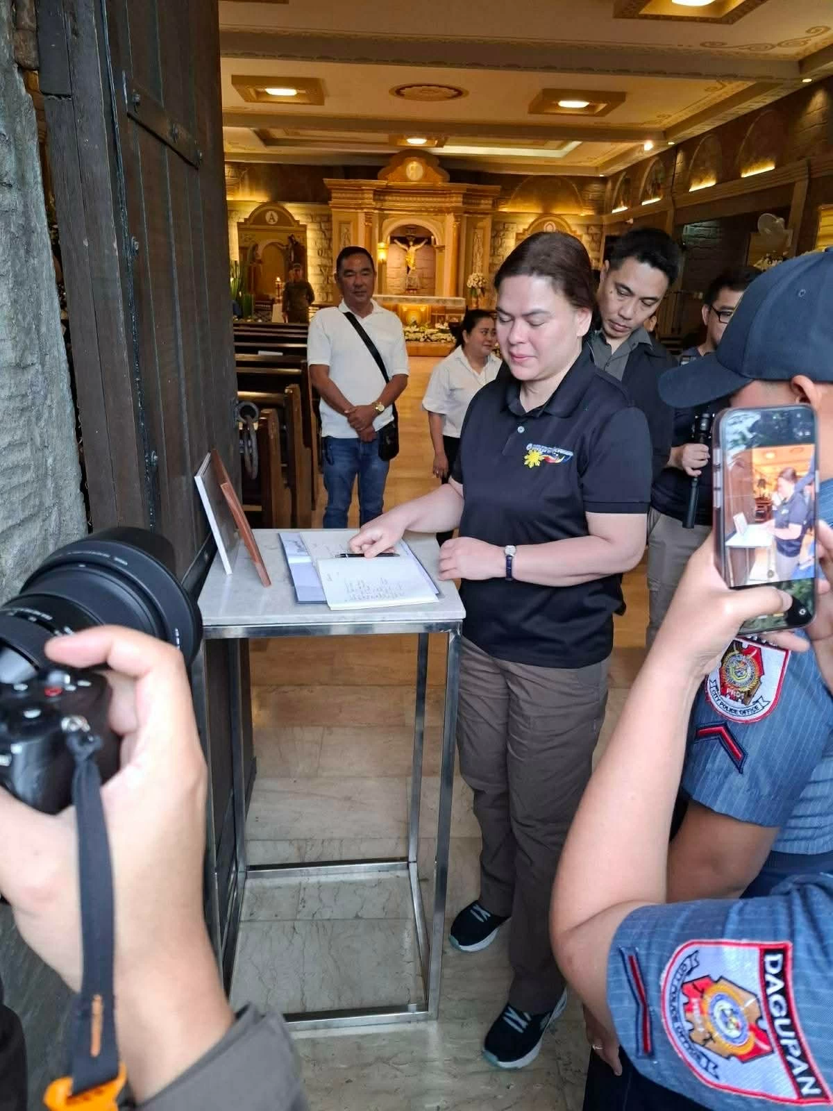 Vice President Sara Duterte signs the funeral guest book at the wake of former House Speaker Jose De Venecia in Dagupan City on Feb. 15, 2026.