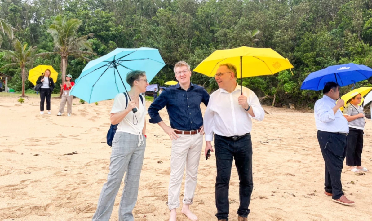 Poland's Head of Mission Katarzyna Wilkowiecka and Finland Ambassador's spouse Jason Tolland shares a light- hearted exchange with Switzerland's Ambassador Nicolas Brühl