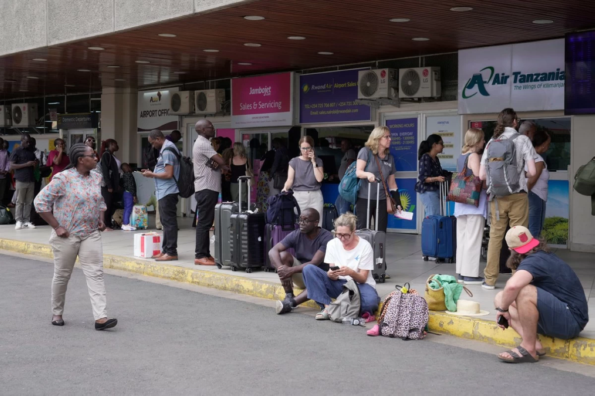 Passengers wait for their delayed flights at Jomo Kenyatta International Airport (JKIA) in Nairobi, Kenya, Monday, Feb. 16, 2026. (AP Photo/Brian Inganga)