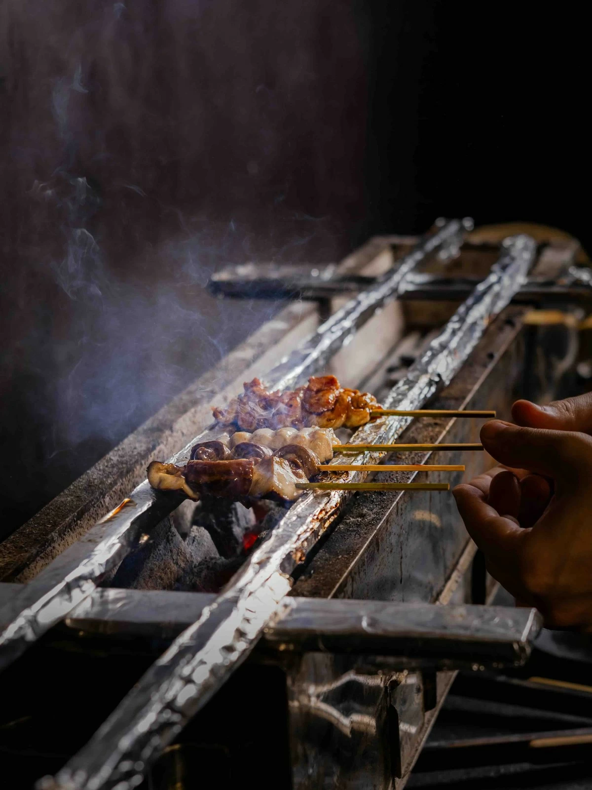 CHARCOAL GLOW Skewers cook over binchotan charcoal, prized for its clean burn and steady heat