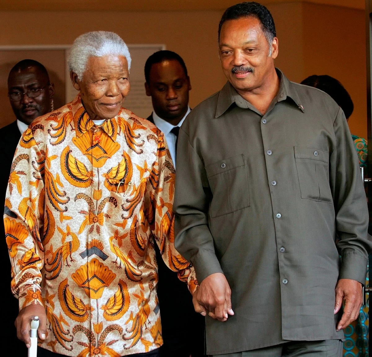 Former South African President Nelson Mandela, left, walks with the Rev. Jesse Jackson after their meeting in Johannesburg, South Africa, Oct. 26, 2005.  (AP Photo/Themba Hadebe, File)