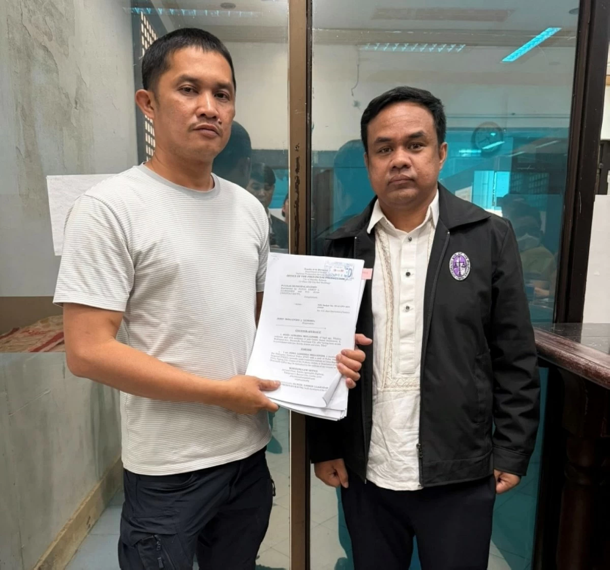 Police Senior Master Sergeant John Mollenido with his lawyer, Cristobal Rimando, in Bulacan (Photo from Rimando's Facebook account) 
