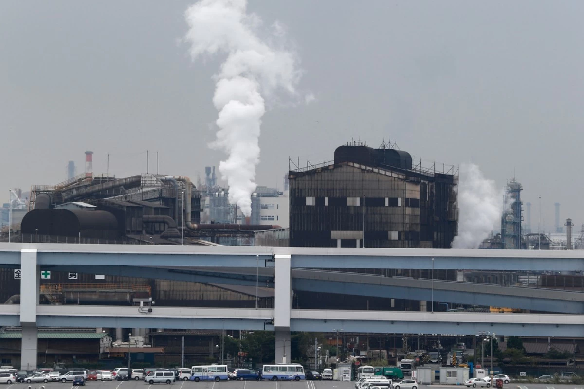 FILE - In this Oct. 21, 2013, file photo, smoke billows from an oil refinery in Kawasaki, southwest of Tokyo. (AP Photo/Koji Sasahara, File)