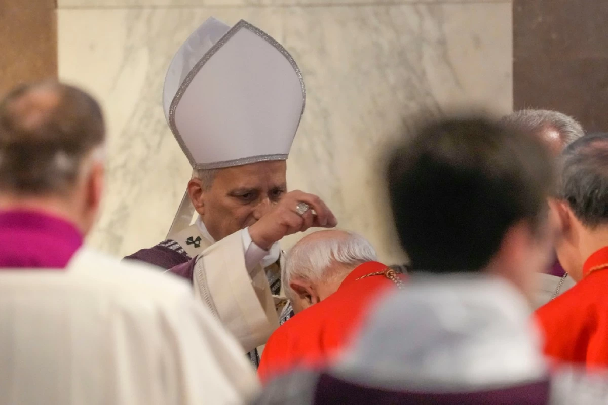Pope Leo XIV administers the ashes during Ash Wednesday Mass, marking the start of Catholic Lent, inside the Basilica of Santa Sabina in Rome, Wednesday, Feb. 18, 2026. (AP Photo/Gregorio Borgia)