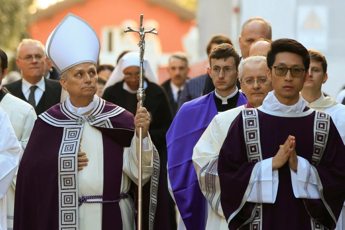 Pope Leo XIV, left, arrives, with bishops and cardinals in a penitential procession marking the start of the Catholic Lent, at the Basilica of Santa Sabina in Rome, Wednesday, Feb. 18, 2026, where he will preside over Ash Wednesday Mass. (AP Photo/Riccardo De Luca)