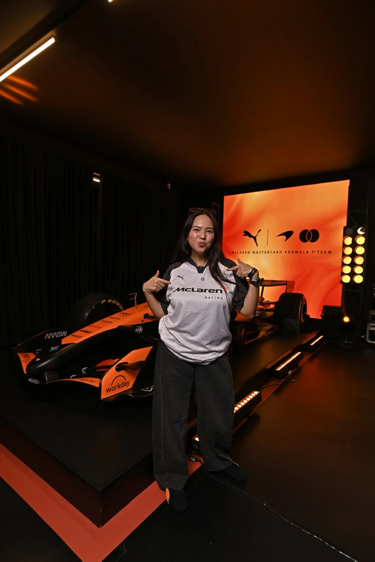 Creator, Chenee Jimenez, in McLaren Racing apparel. 