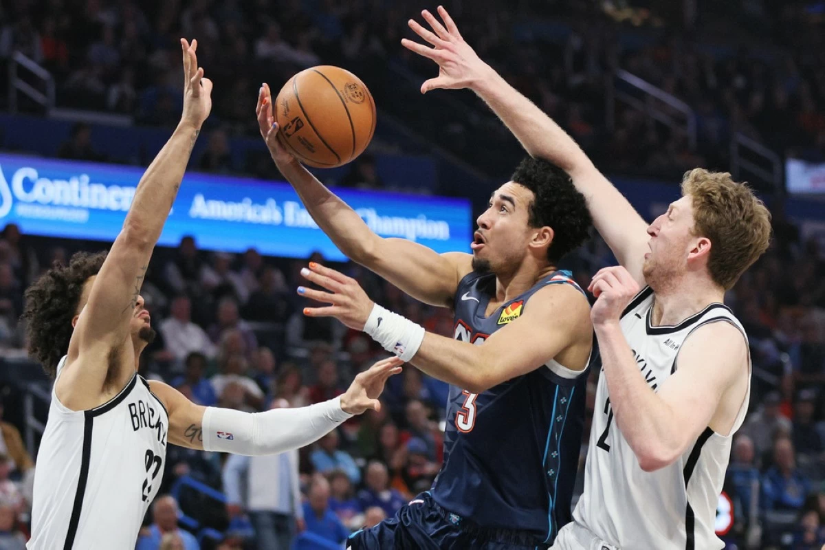 Oklahoma City Thunder guard Jared McCain (3) looks to score between Brooklyn Nets forwards Jalen Wilson, left, and Danny Wolf, right, during the second half of an NBA basketball game Friday, Feb. 20, 2026, in Oklahoma City. (AP Photo/Nate Billings)