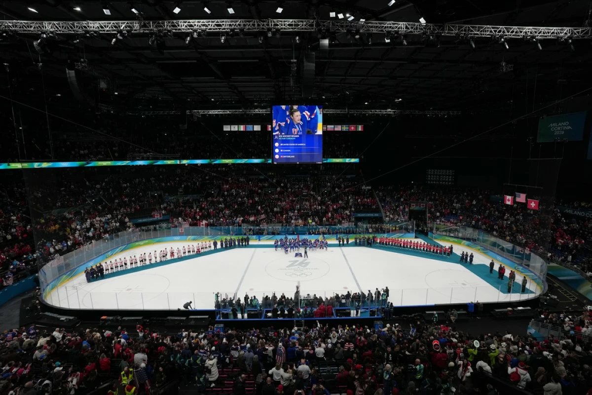 Teams from the United States, Canada and Switzerland receive their medals following the women's ice hockey gold medal game at the 2026 Winter Olympics, in Milan, Italy, Thursday, Feb. 19, 2026. (AP Photo/Carolyn Kaster)