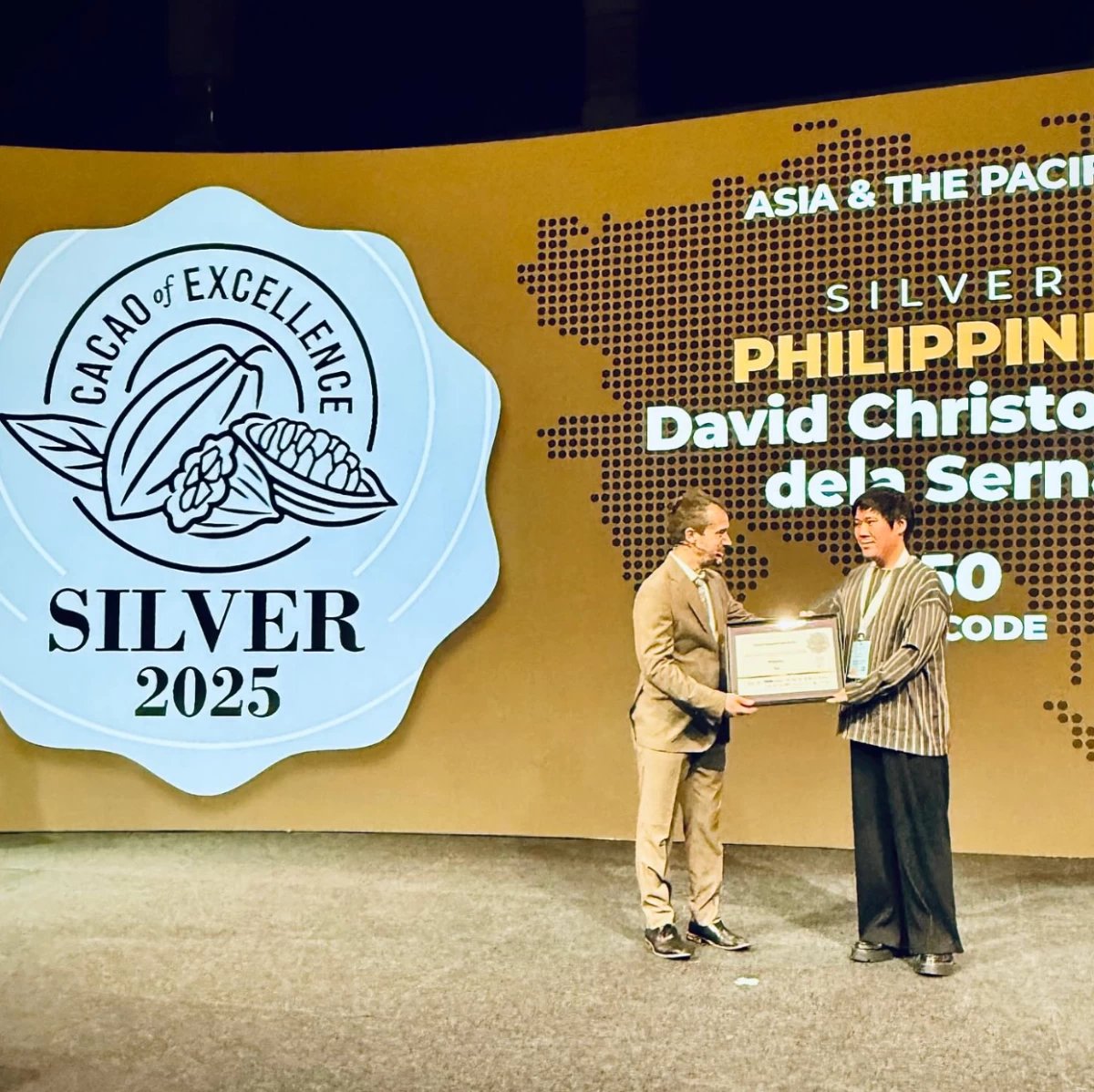 GLOBAL HONOR Mark Ocampo of Auro Chocolate receives the silver recognition on behalf of Davao farmer David dela Serna at the Cacao of Excellence Awards ceremony in Amsterdam, marking another milestone for Philippine cacao on the world stage.