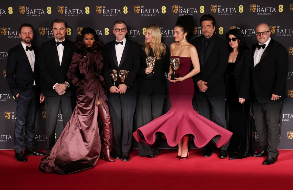 Director Paul Thomas Anderson (Center), Andy Jurgensen, Sara Murphy, Cassandra Kulukundis, Michael Bauman, and cast members Leonardo DiCaprio, Benicio Del Toro, Teyana Taylor and Chase Infiniti celebrate multiple wins for One Battle After Another at the British Academy of Film and Television Awards (AP) 