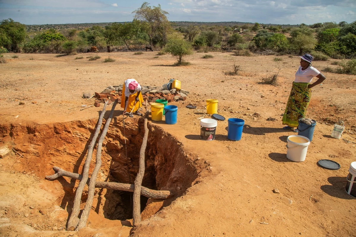 FILE -  Villagers fetch water from a makeshift borehole in Mudzi, Zimbabwe, Tuesday, July 2, 2024. as the United Nations' food agency says months of drought in southern Africa, triggered by the El Nino weather phenomenon, has had a devastating impact on more than 27 million people and caused the region's worst hunger crisis in decades. (AP Photo/Aaron Ufumeli, File)