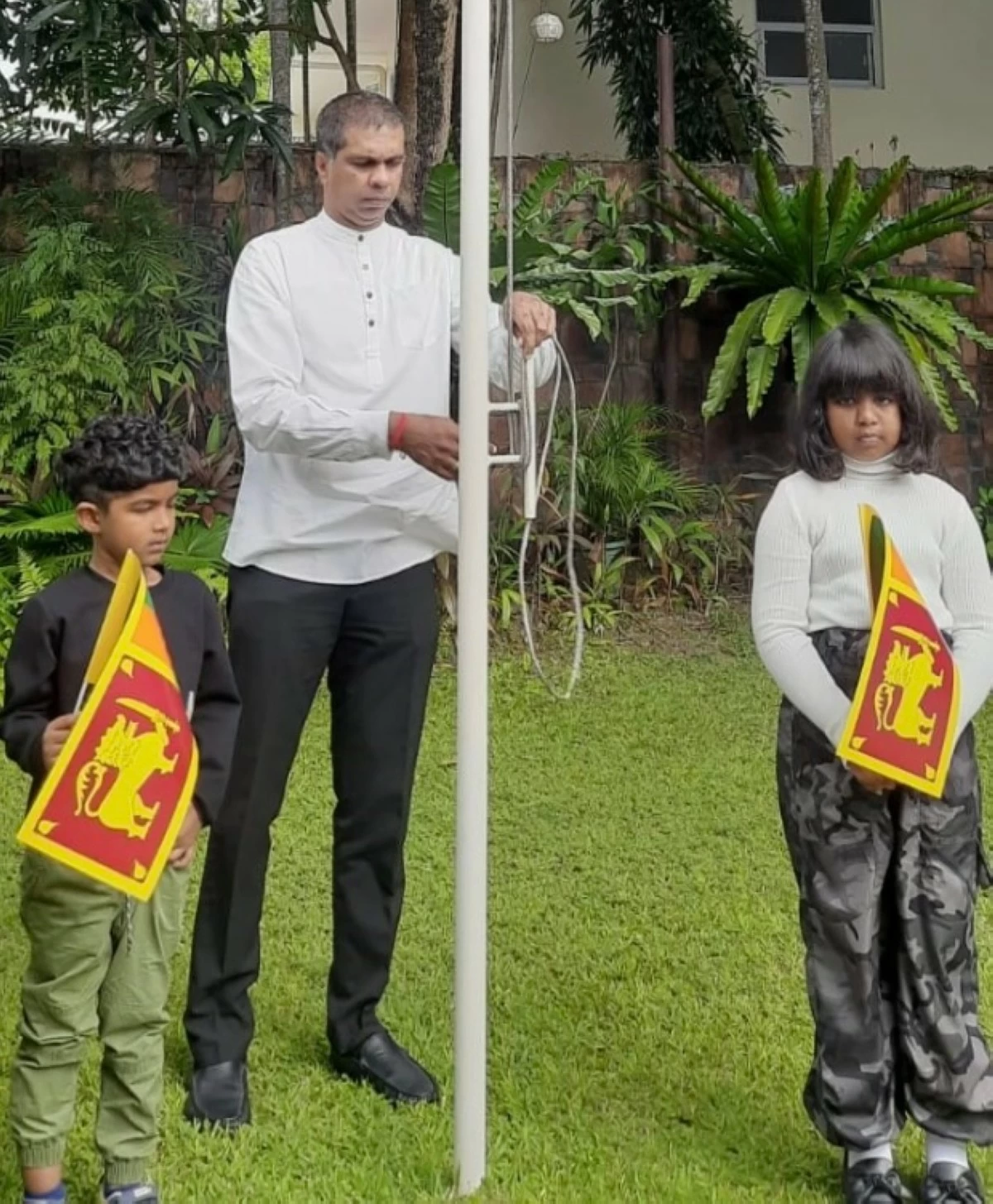 Ambassador Dr. Chanaka Talpahewa hoists the National Flag of Sri Lanka.