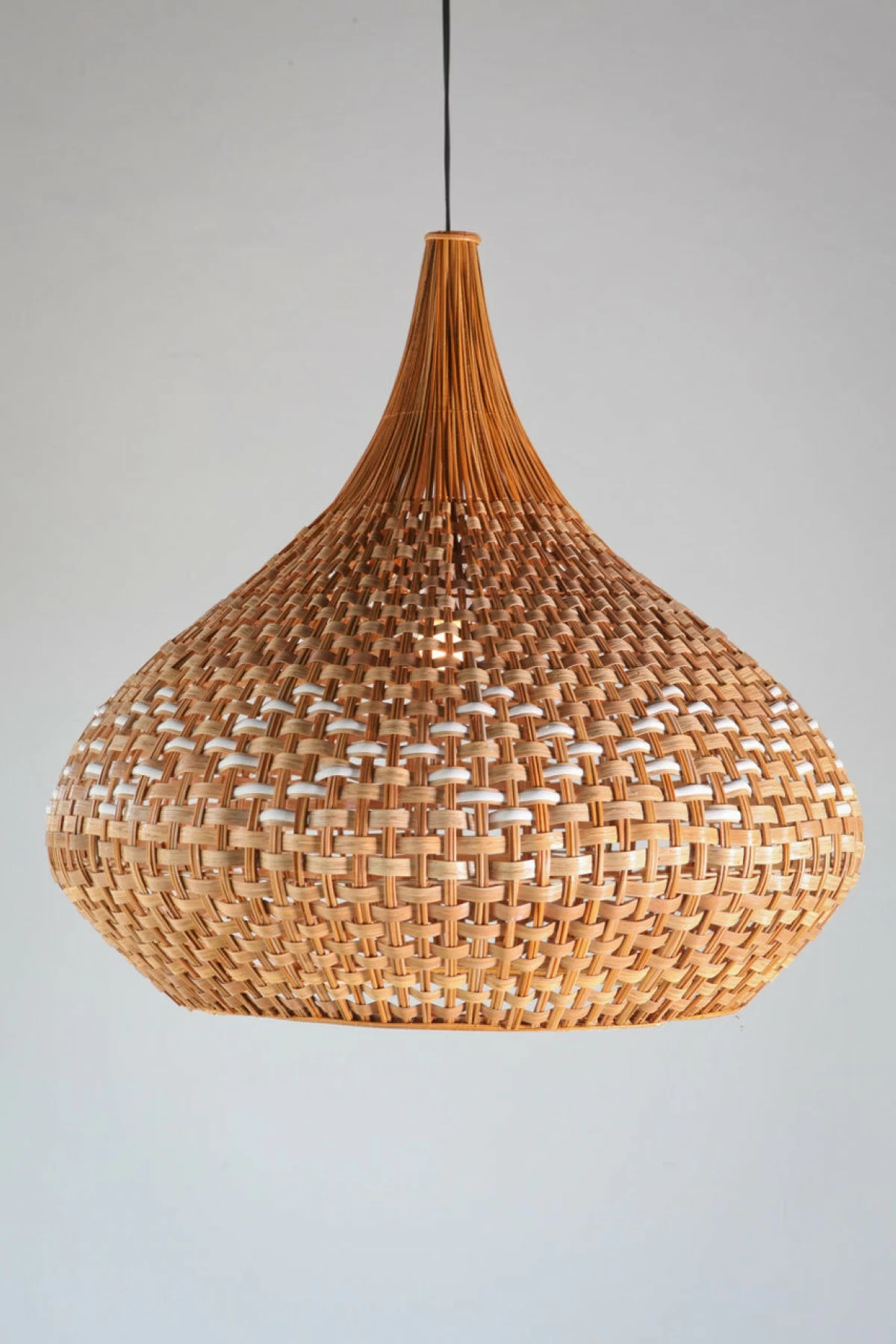 The Lala Uno hanging lamp in buri and bamboo, inspired by Philippine mat weaving traditions, was designed by Christina Gaston.