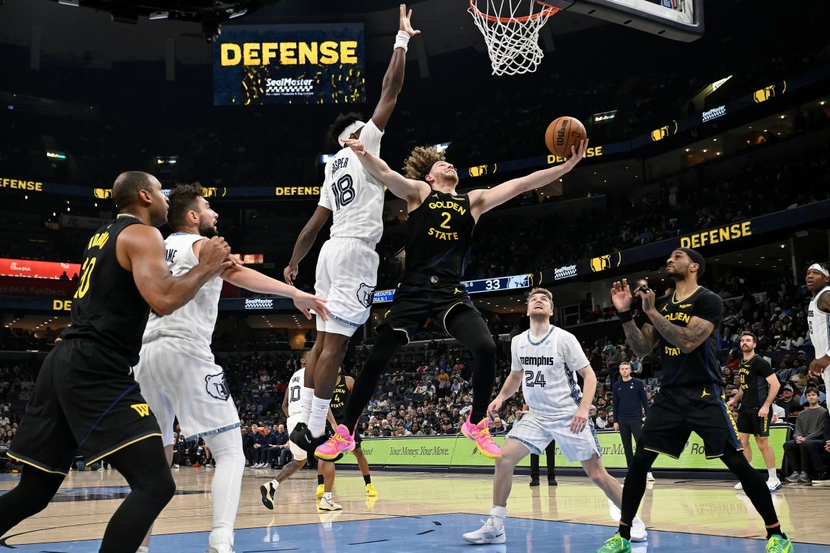 Golden State Warriors guard Brandin Podziemski (2) shoots against Memphis Grizzlies forward Olivier-Maxence Prosper (18) in the first half of an NBA basketball game, Wednesday, Feb. 25, 2026, in Memphis, Tenn. (AP Photo/Brandon Dill)
