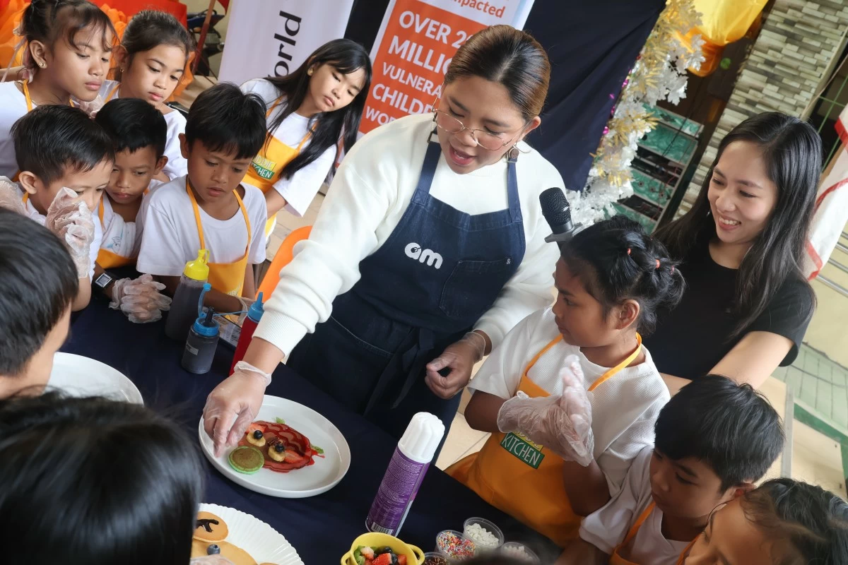 Abi leading a kitchen workshop for children in partnership with World Vision