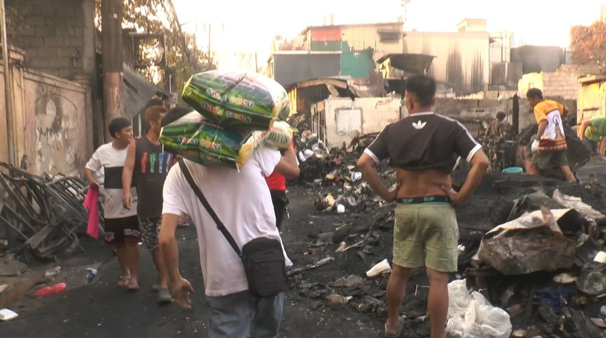Volunteers carry sacks of rice, dubbed “Bags of Hope,” for distribution to families affected by the Feb. 25 fire in Intramuros, Manila.