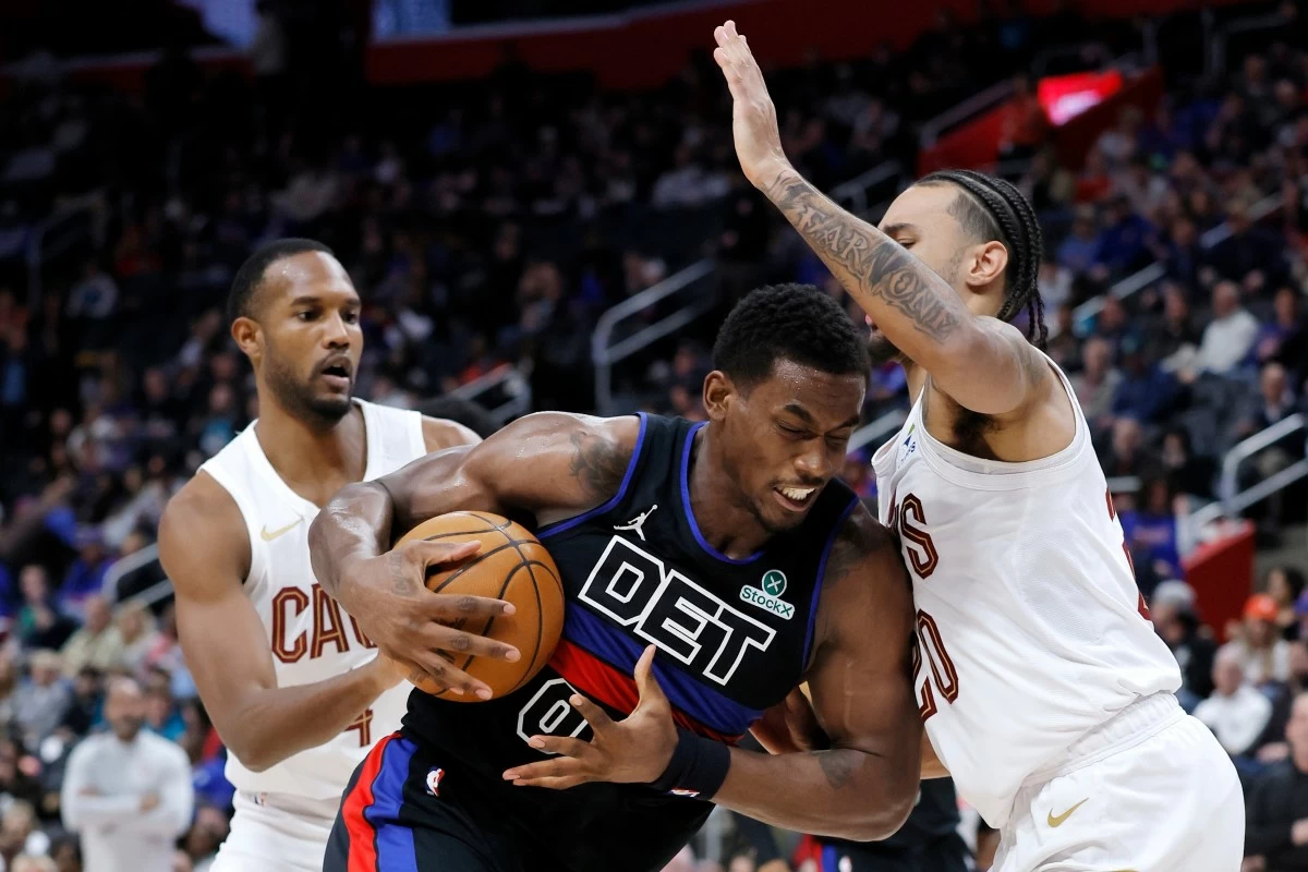 Detroit Pistons center Jalen Duren (0) drives to the basket against Cleveland Cavaliers guard Jaylon Tyson, right, during the first half of an NBA basketball game Friday, Feb. 27, 2026, in Detroit. (AP Photo/Duane Burleson)