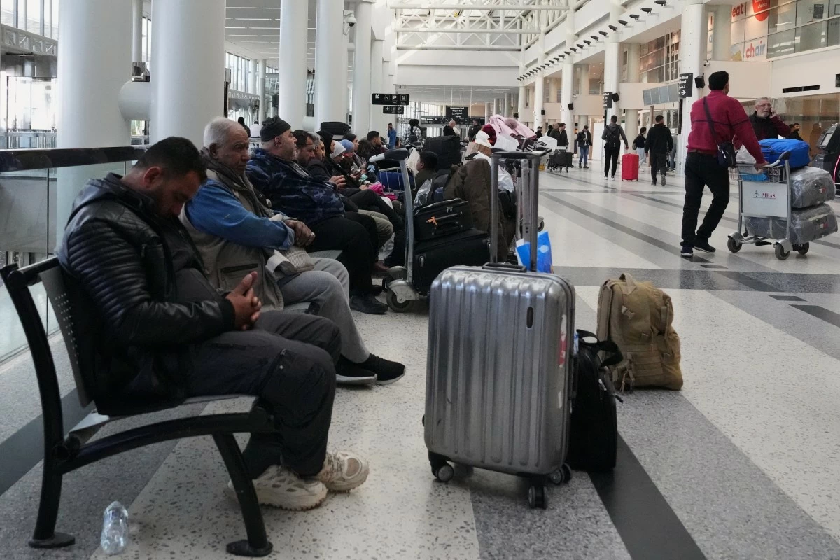 Passengers whose flights were cancelled, wait at the departure terminal of Rafik Hariri International Airport in Beirut, Lebanon, Saturday, Feb. 28, 2026, as many airlines canceled flights due to the conflict involving the United States, Israel and Iran. (AP Photo/Hassan Ammar)