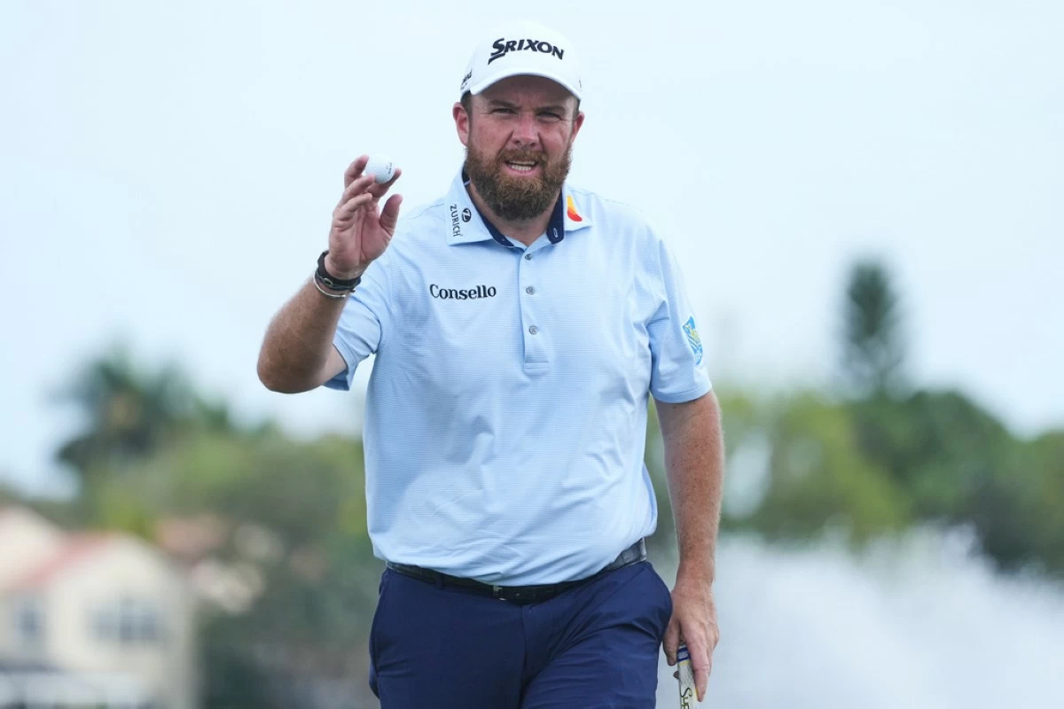 Shane Lowry of Ireland shows his ball on the 18th green during the third round of the Cognizant Classic golf tournament, Saturday, Feb. 28, 2026, in Palm Beach Gardens, Fla. (AP Photo/Marta Lavandier)