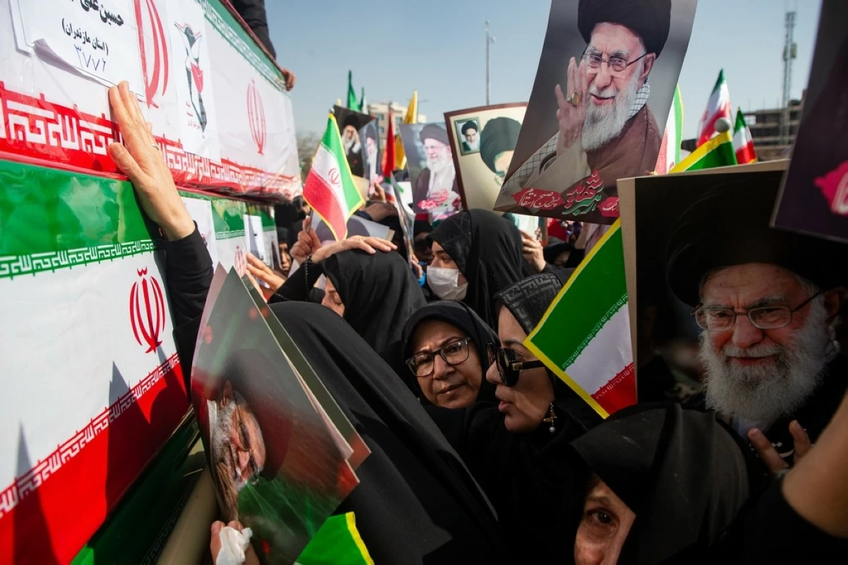 Some holding pictures of  the late Iranian Supreme Leader Ayatollah Ali Khamenei, mourners reach out to coffins during a funeral for people killed during the ongoing U.S.–Israeli military campaign in Isfahan, Iran, Thursday, March 5, 2026. (Payman Shahsanaei/ISNA via AP)