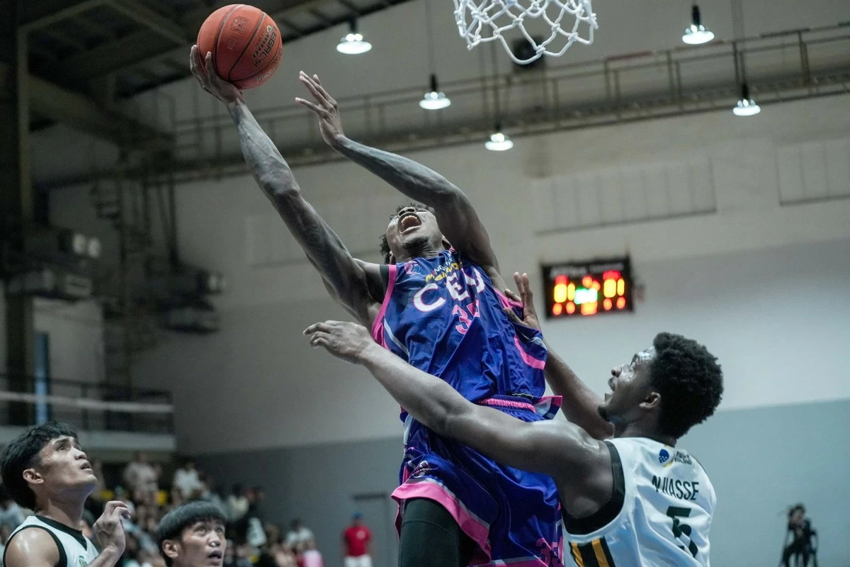 CEU’s Precious Momowei goes for a basket against Olivarez College’s Hakim Njiasse during their duel in the PGFlex-UCAL Season 8 Basketball Tournament on March 5 at the Paco Arena. (UCAL)