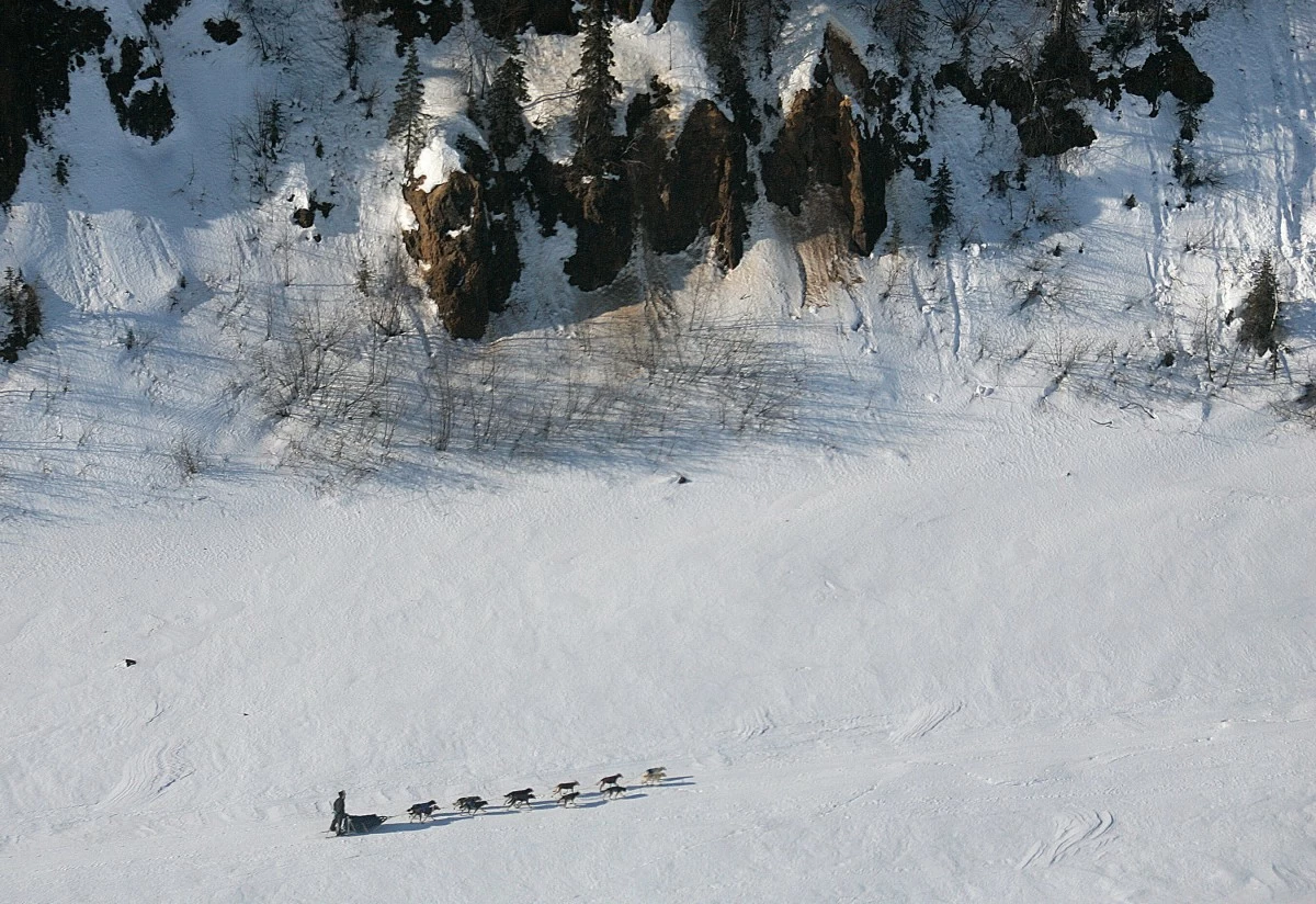 RYAN Redington of Knik, Alaska, grandson of Joe Redington Sr., the father of the Iditarod, drives his team on the Yukon River past the bluffs near Grayling, Alaska, on the Iditarod Trail Sled Dog Race, March 10, 2007. (AP)