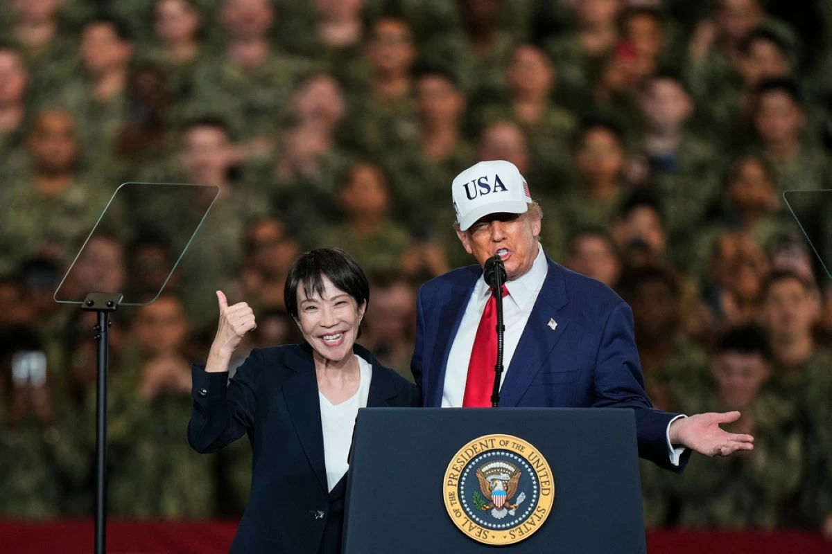 Japanese Prime Minister Sanae Takaichi gestures as U.S. President Donald Trump delivers his speech during their visit to the aircraft carrier USS George Washington at the U.S. Navy's Yokosuka base in Yokosuka, south of Tokyo, on Oct. 28, 2025. (AP Photo/Eugene Hoshiko, File)