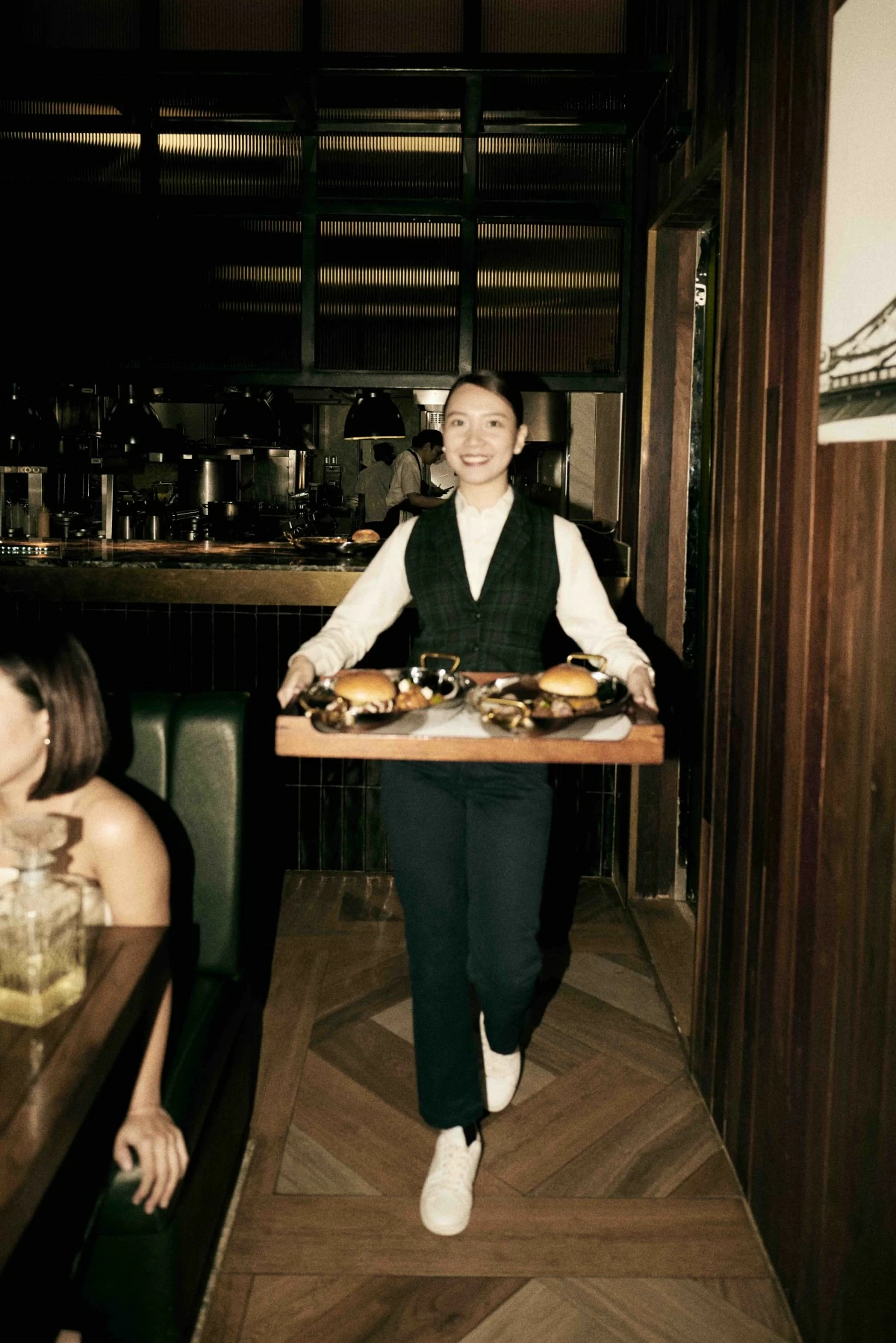 SERVICE SMILES Staff present a tray of burgers during the launch of Dirty Fridays