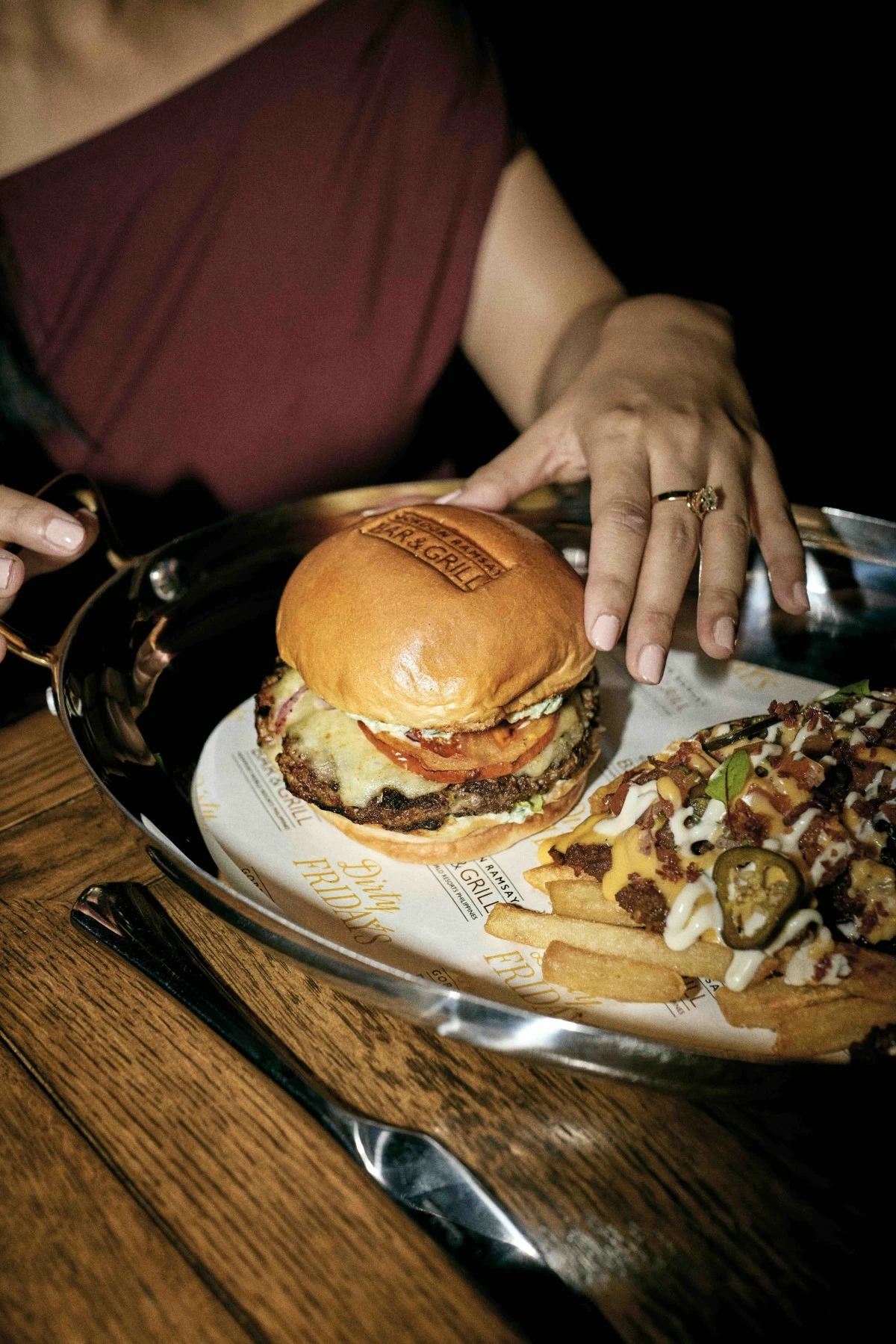 LAMB BURGER The lamb burger layered with tzatziki, baby gem lettuce, and red onion pickle.