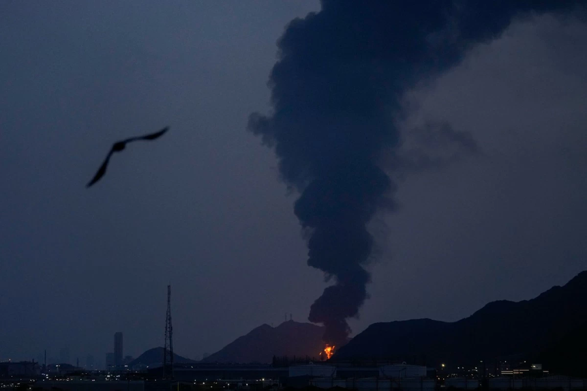 Large fire and plume of smoke is visible after, according to the authorities, debris of an Iranian intercepted drone hit the Fujairah oil facility, in Fujairah, United Arab Emirates, Tuesday, March 3, 2026. (AP Photo/Altaf Qadri)