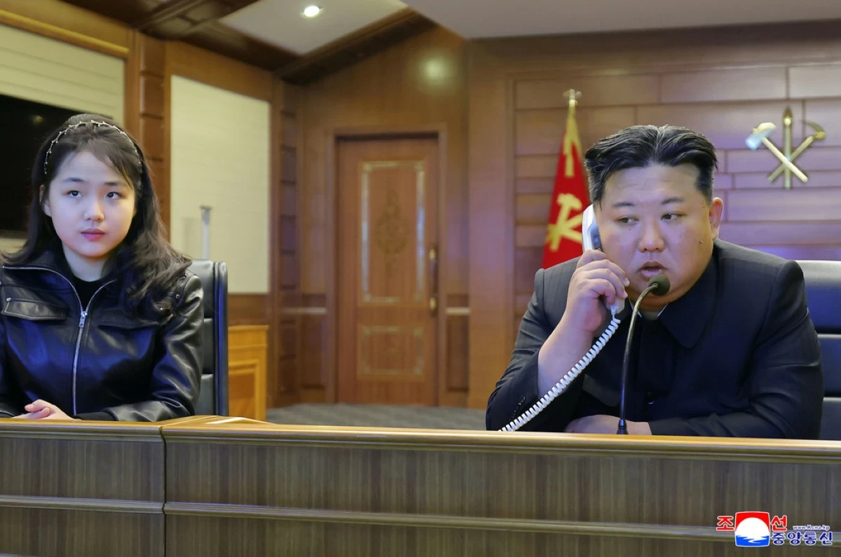 This photo provided by the North Korean government shows its leader Kim Jong Un, right, and his daughter, left, watch what it says the cruise missiles launches from the naval destroyer, the Choe Hyon, via video Tuesday, March 10, 2026, in North Korea. (Korean Central News Agency/Korea News Service via AP)
