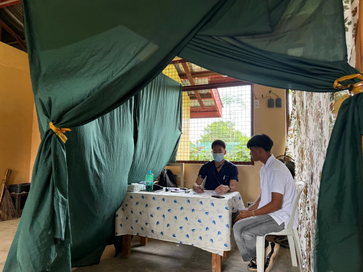 An Ayala Group volunteer conducts a medical consultation during a relief operation, supporting Ayala Foundation's drive to mobilize skilled professionals for communities.